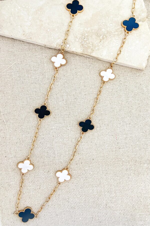 Long gold necklace with black and white clover detail